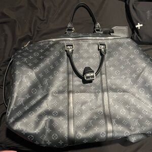 Black Louis Vuitton duffel bag keepall Bandouliere.